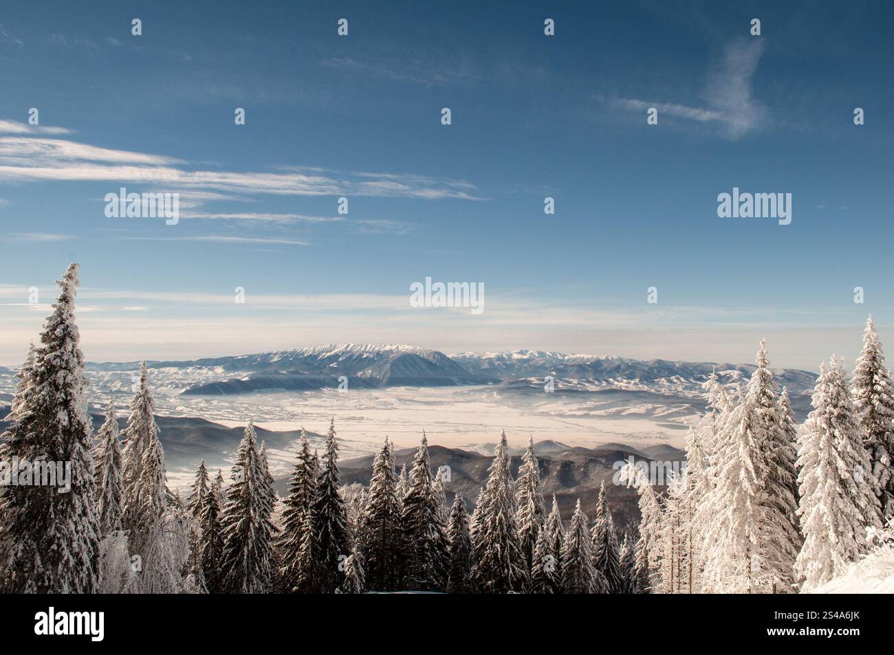 Une vue panoramique à couper le souffle sur les montagnes Piatra Craiului vues depuis les pentes enneigées du massif de Postavaru. L'air frais de l'hiver et les s clairs Banque D'Images