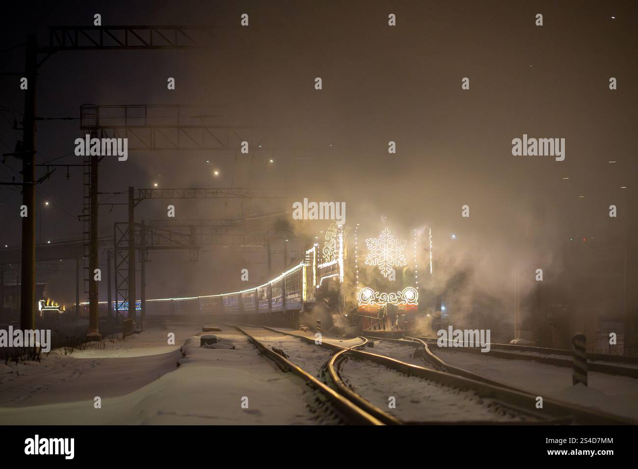 Train à vapeur rétro de Noël la nuit dans la ville la veille de Noël et le nouvel an en Russie. Banque D'Images