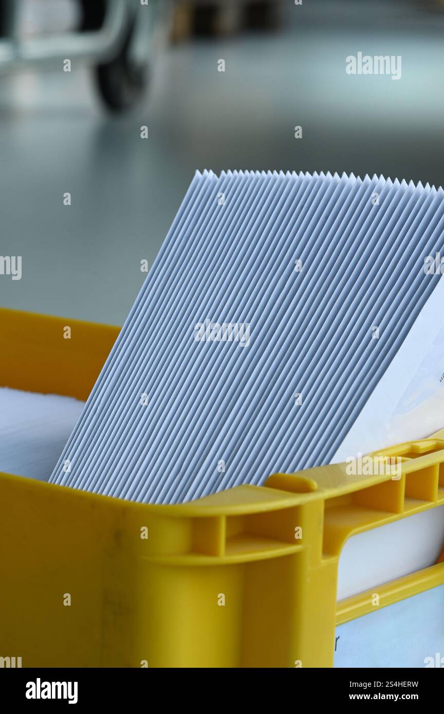 Boîte aux lettres avec courrier trié par code postal pour l'optimisation de la livraison et de l'affranchissement lors de l'envoi du courrier. Insertion de la production d'impression de lettres de courrier machine. Banque D'Images