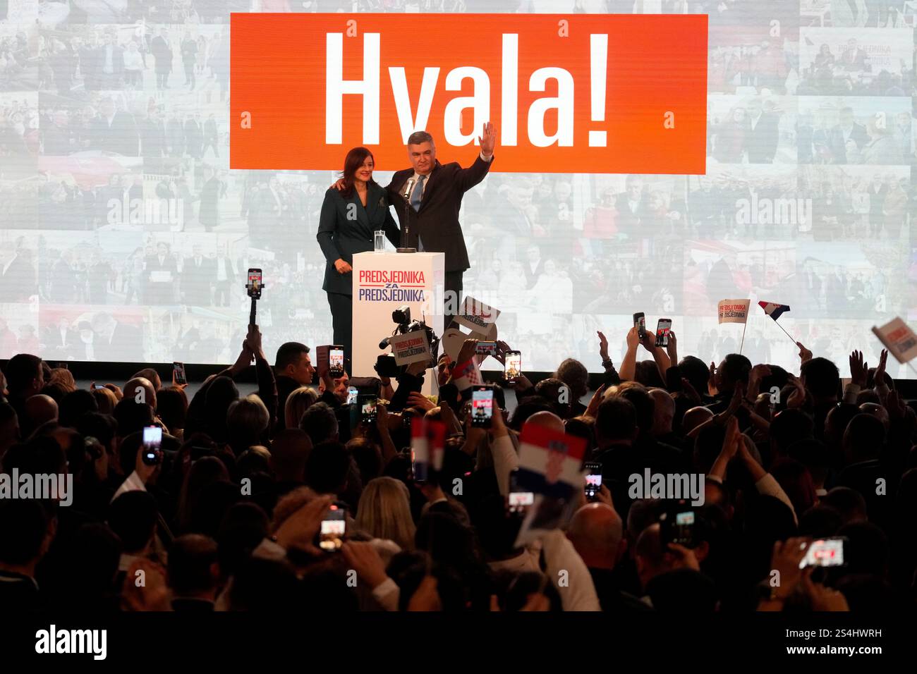 President incumbent Zoran Milanovic with his wife Sanja Music Milanovic greets his supporters as the preliminary results grant him victory in a runoff vote for the Croatian presidential election in Zagreb, Croatia, Sunday, Jan. 12, 2025. The sign reads "Thank You". (AP Photo/Darko Bandic) Banque D'Images