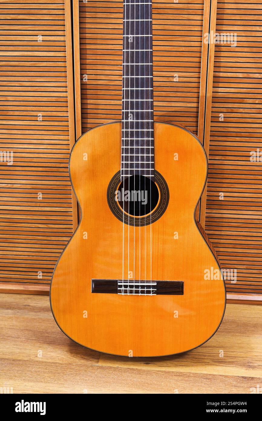 Guitare acoustique classique près de mur en bois Banque D'Images