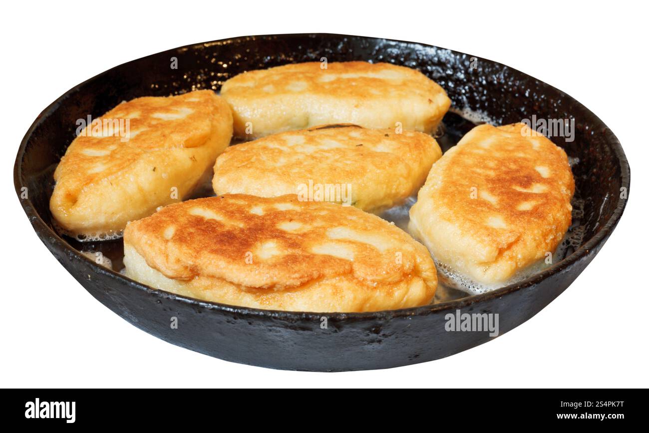 Quelques galettes avec oignon de printemps et les oeufs dans une poêle isolé sur fond blanc Banque D'Images