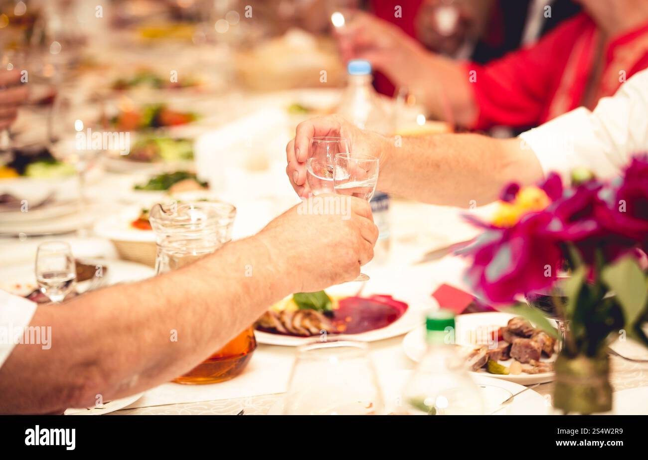 Gros plan photo de deux hommes serrant des lunettes avec de la vodka au restaurant Banque D'Images