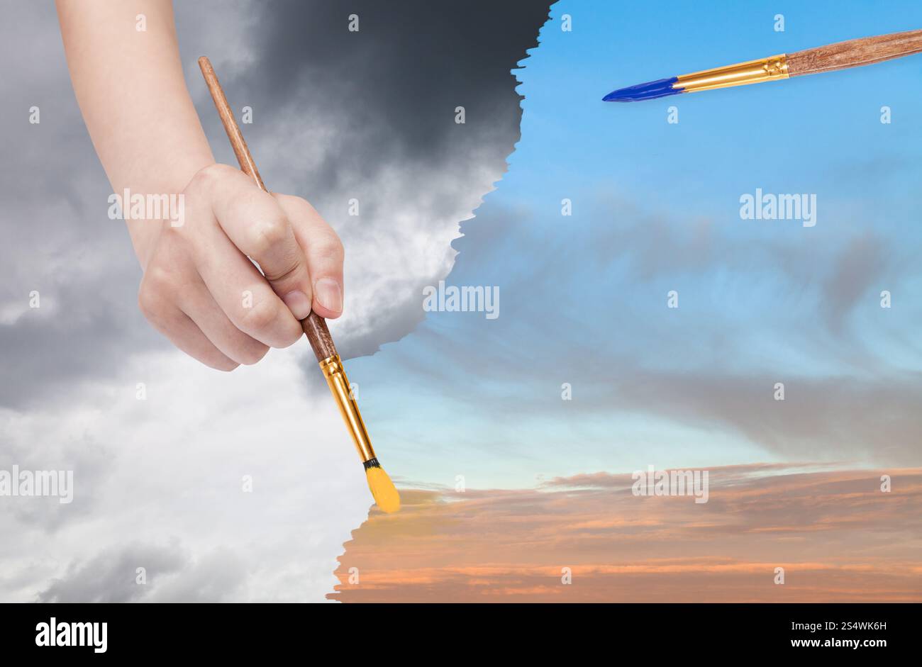 Concept nature - les saisons et la météo change : la main avec des peintures pinceau au lieu de ciel coucher de soleil nuages de pluie Banque D'Images