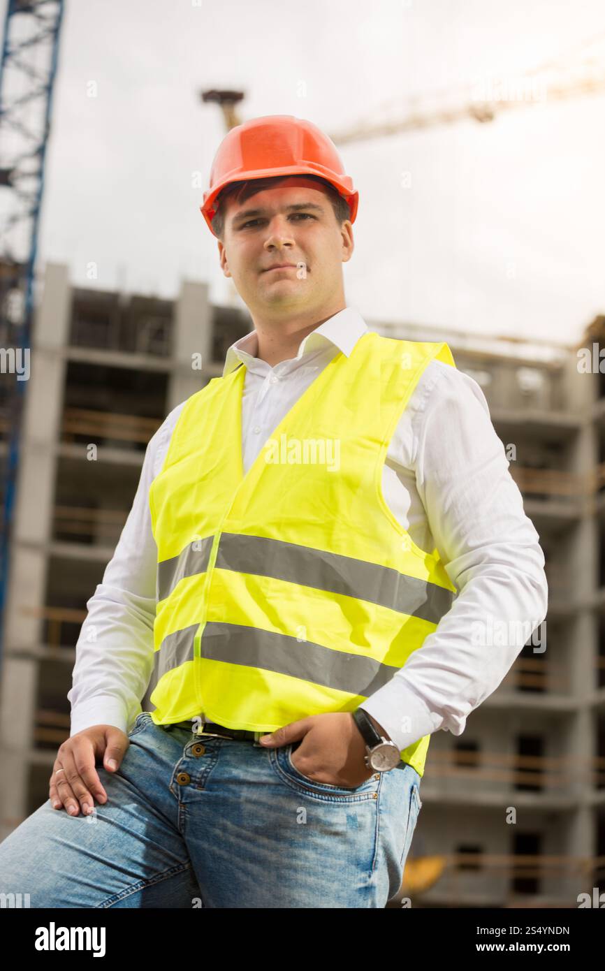 Ingénieur de construction souriant dans le casque regardant la caméra Banque D'Images