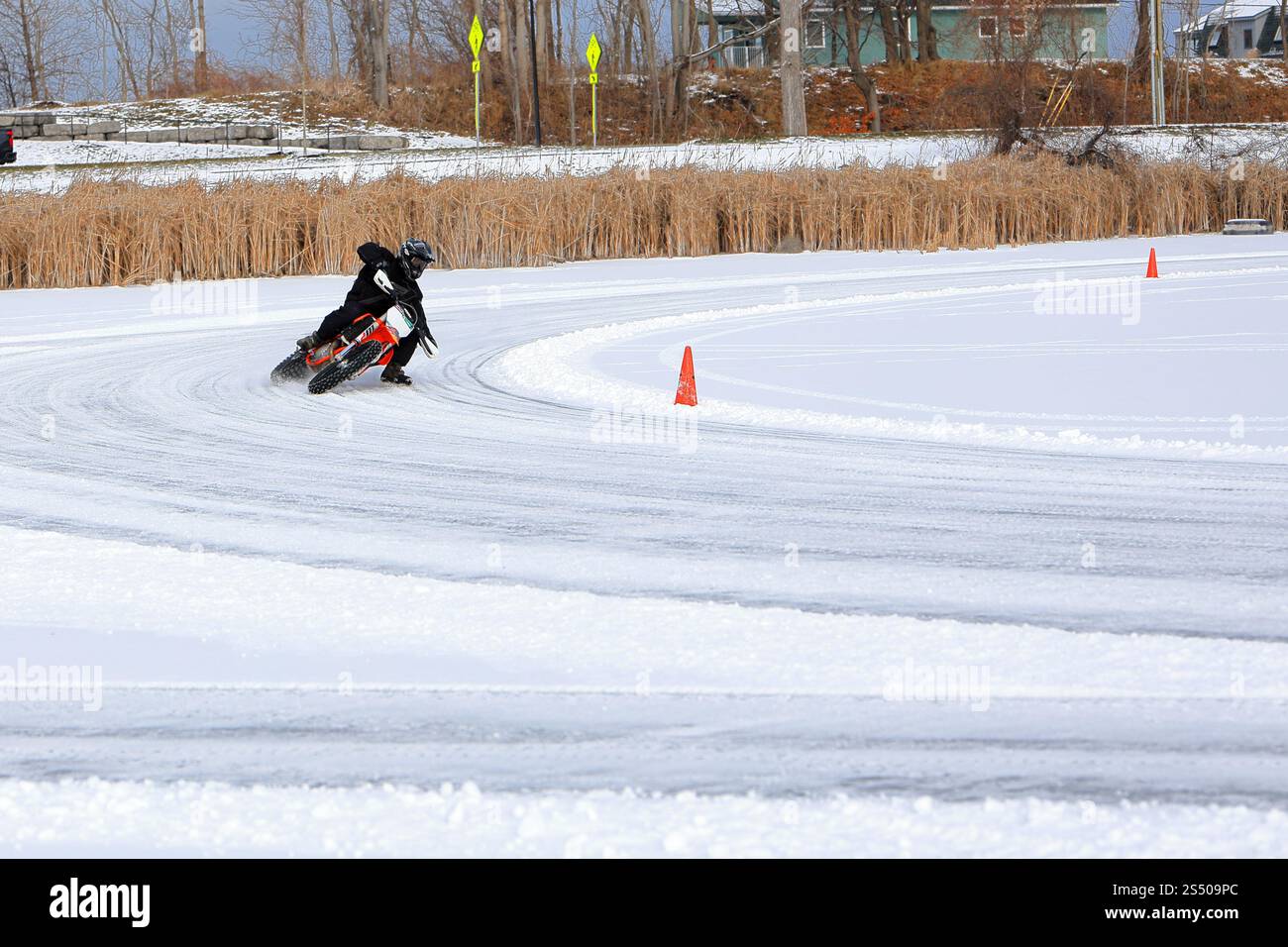 Webster, NY, USA - 11 janvier 2025 - les motards courent autour d'un circuit de glace dans le nord de l'État de New York. Les pneus cloutés et les techniques d'inclinaison fournissent Banque D'Images