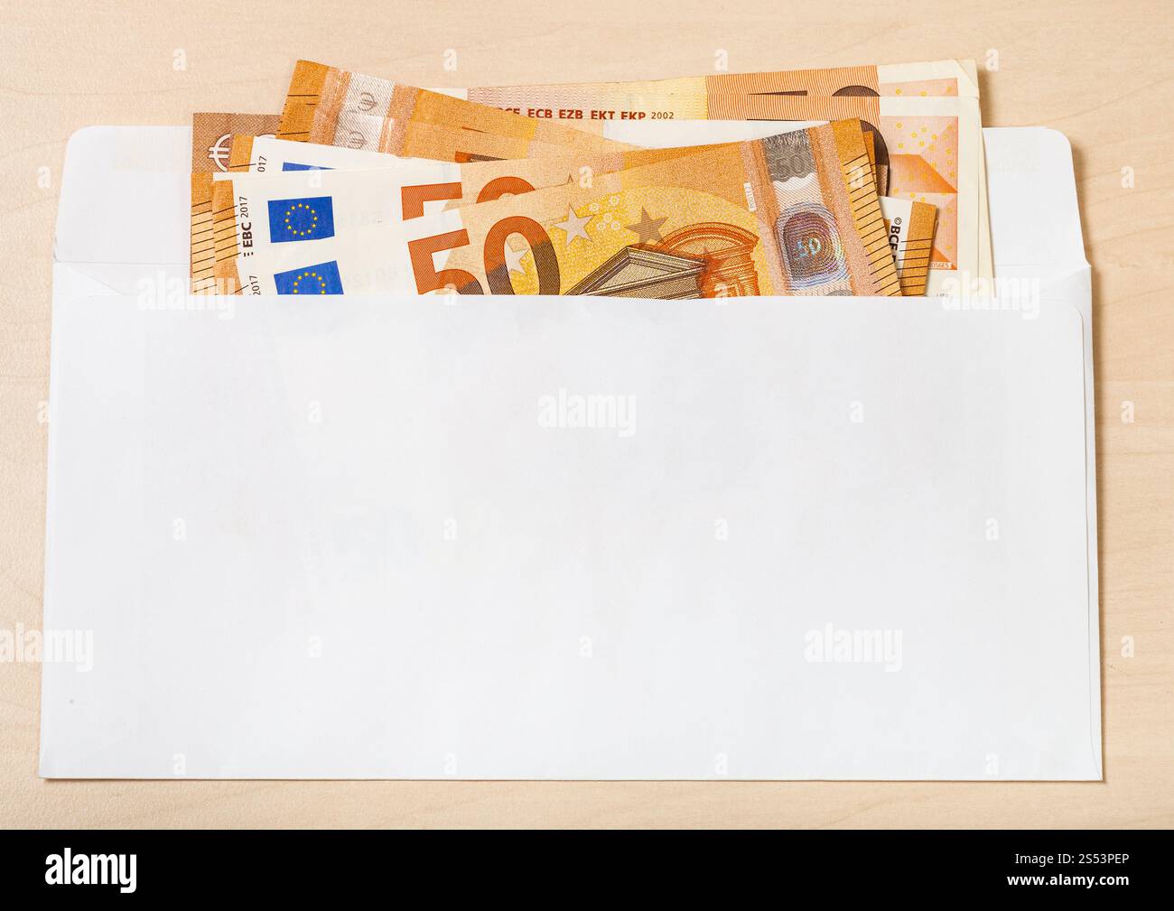 Plusieurs Cinquante billets d'euros à ouvrir le courrier enveloppe sur table en bois Banque D'Images
