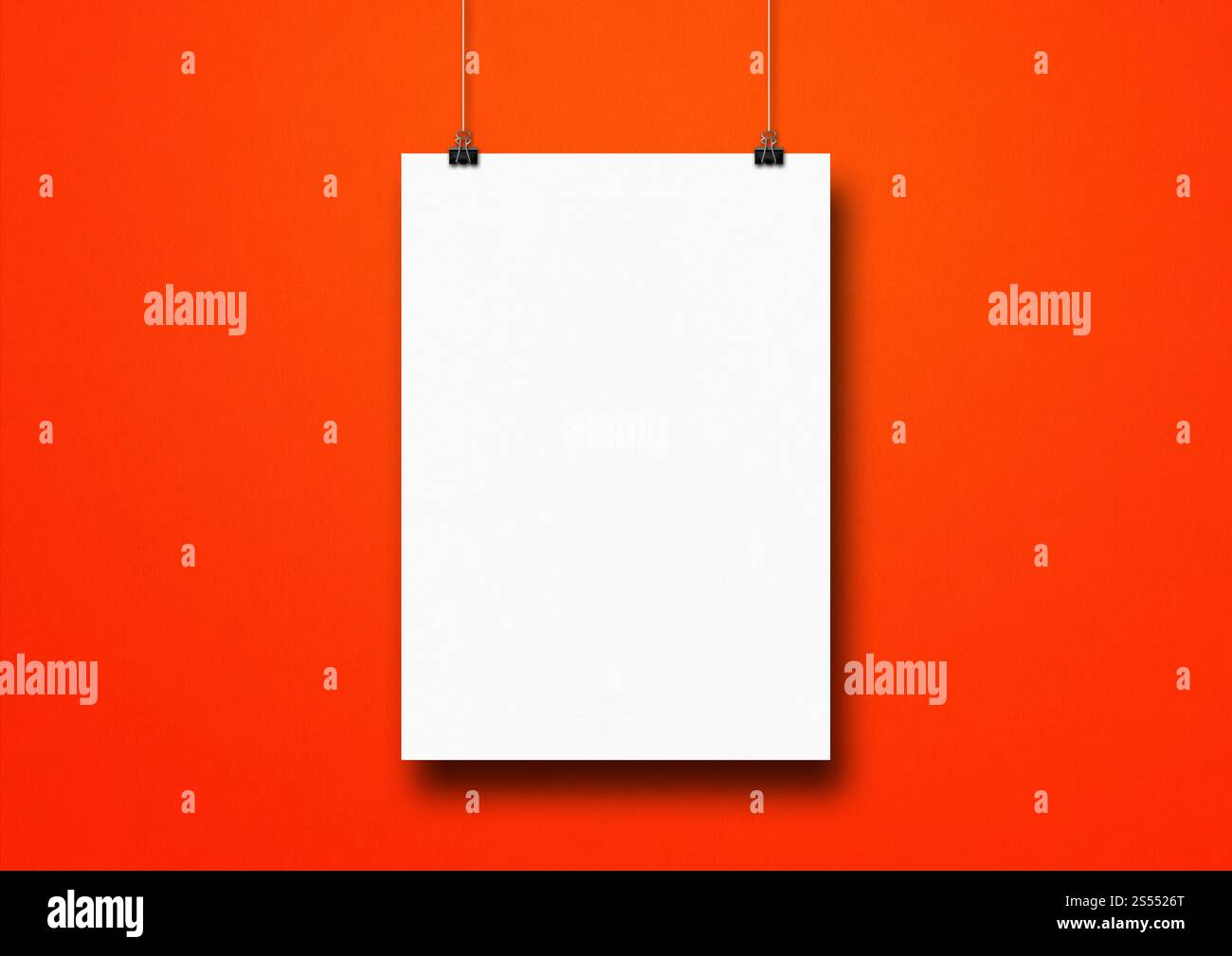 Affiche blanche accrochée sur un mur rouge avec des clips. Modèle de maquette vierge. Affiche blanche accrochée sur un mur rouge avec des clips Banque D'Images