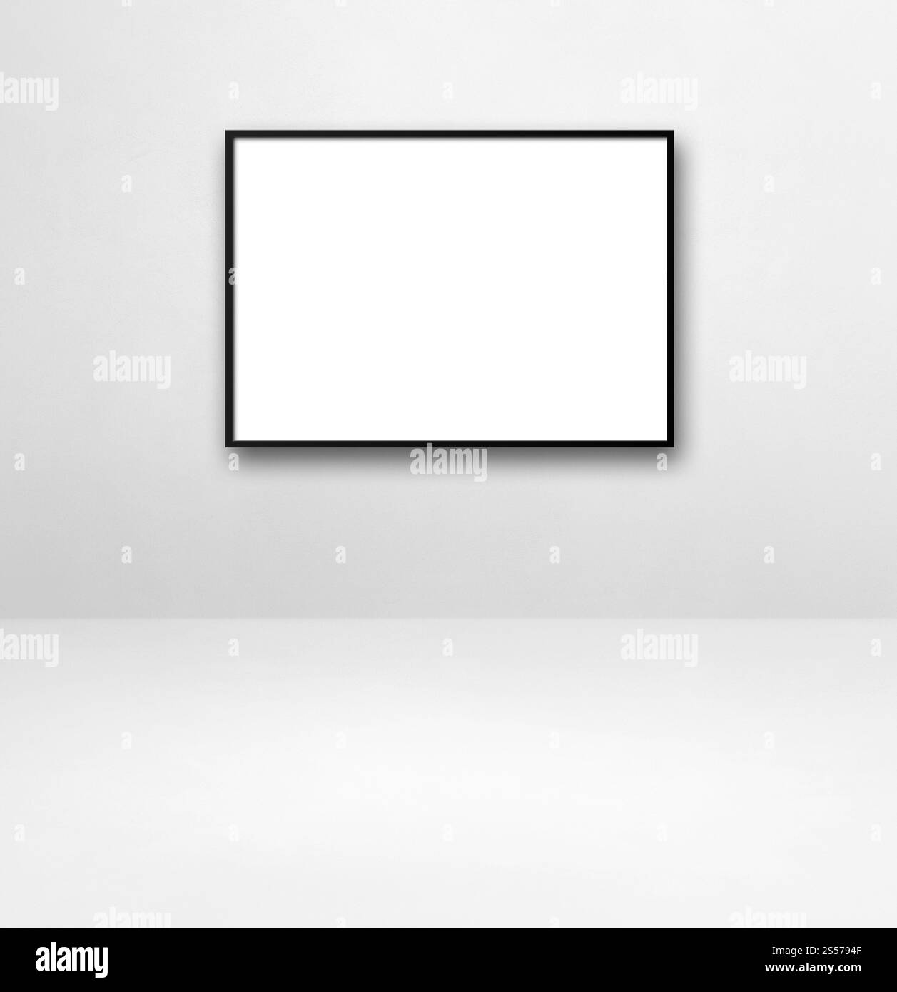 Cadre photo noir accroché sur un mur blanc. Modèle de maquette vierge. Cadre photo noir accroché sur un mur blanc Banque D'Images