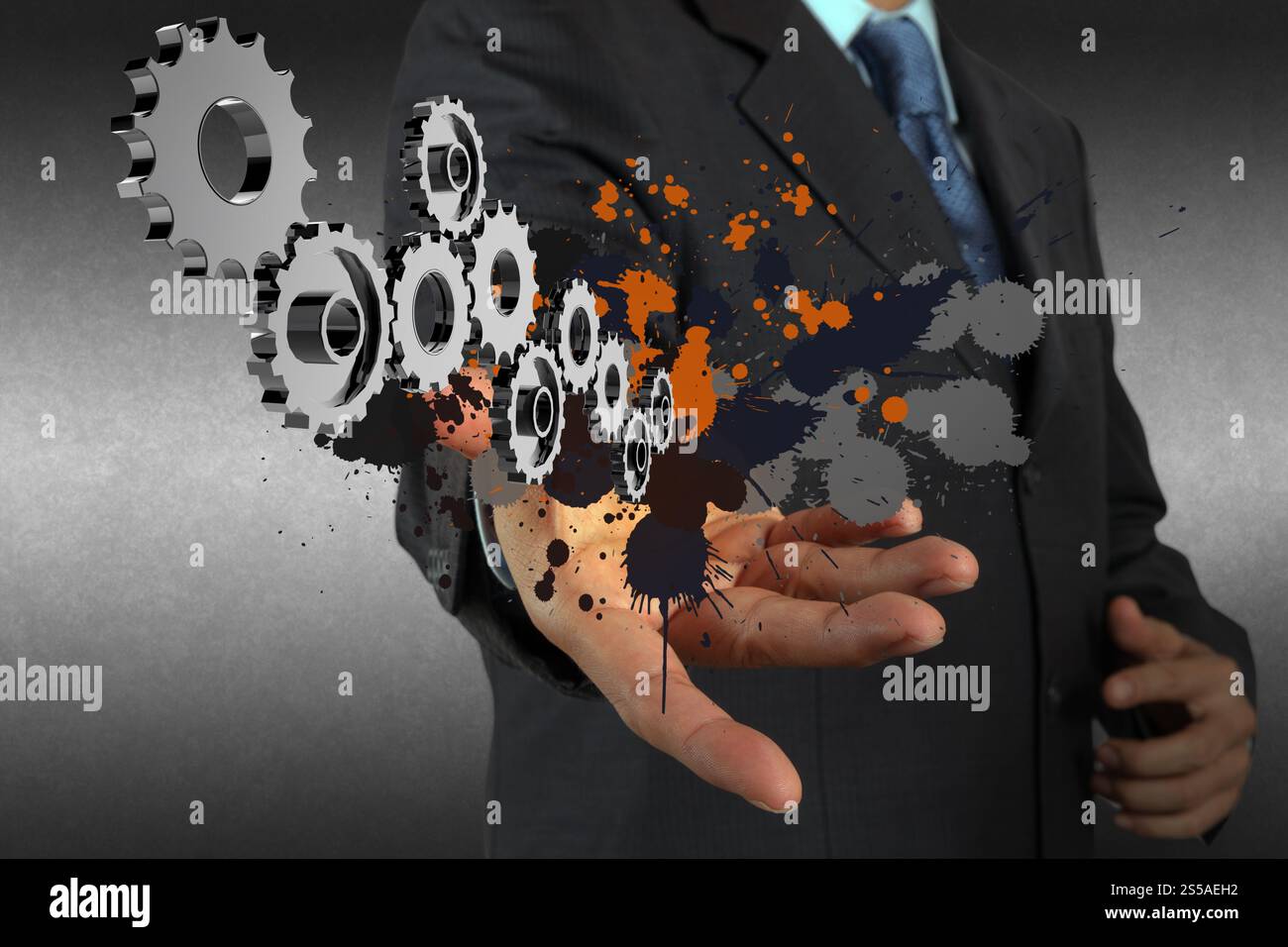 Businessman working avec pignon et splash couleurs en tant que concept Banque D'Images