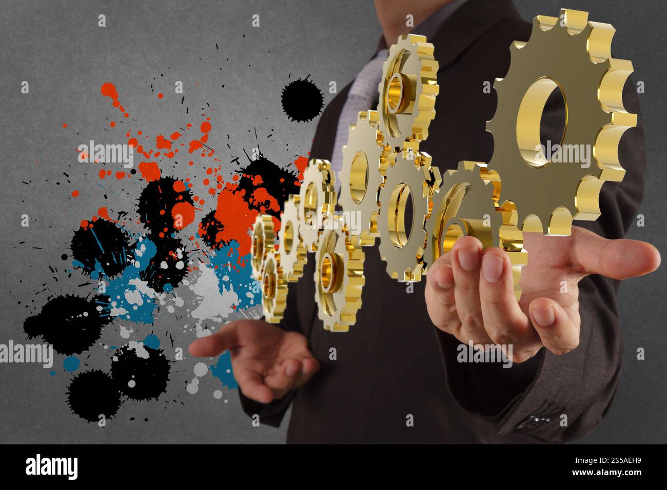 Businessman working avec pignon et splash couleurs en tant que concept Banque D'Images