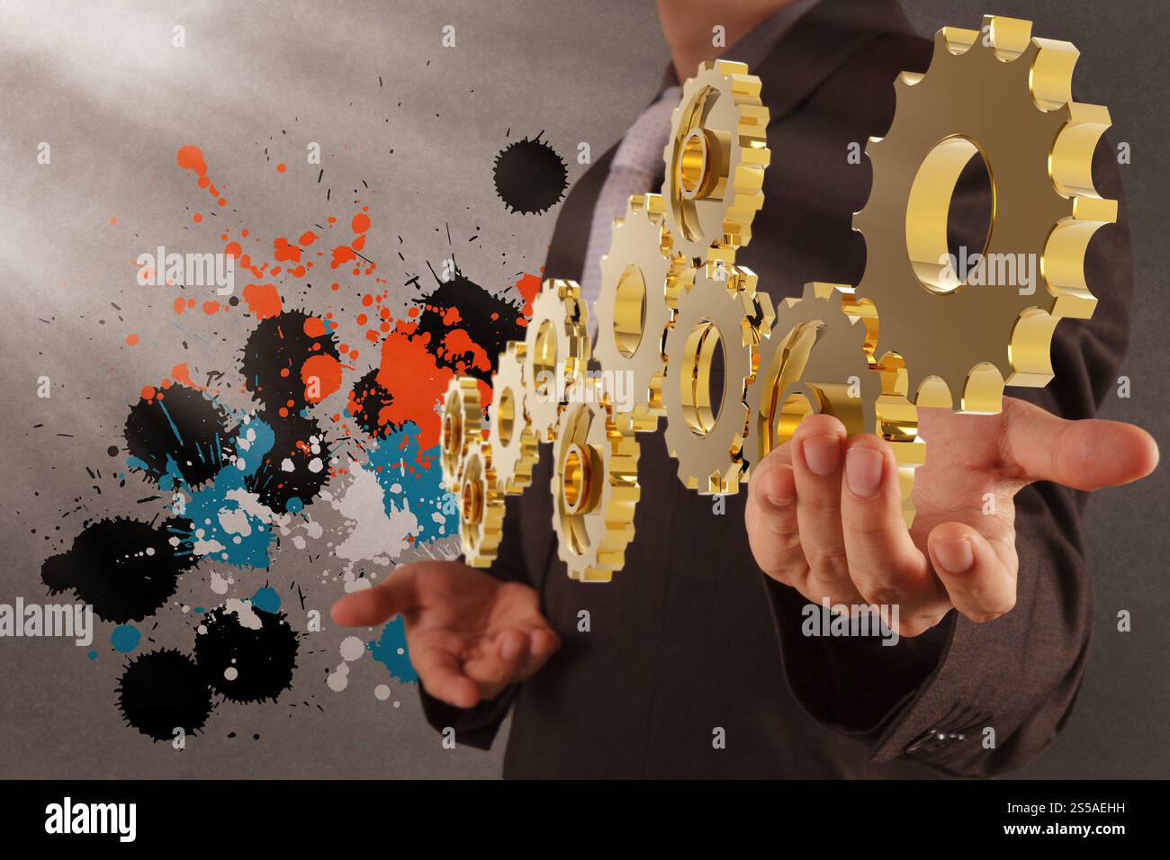 Businessman working avec pignon et splash couleurs en tant que concept Banque D'Images