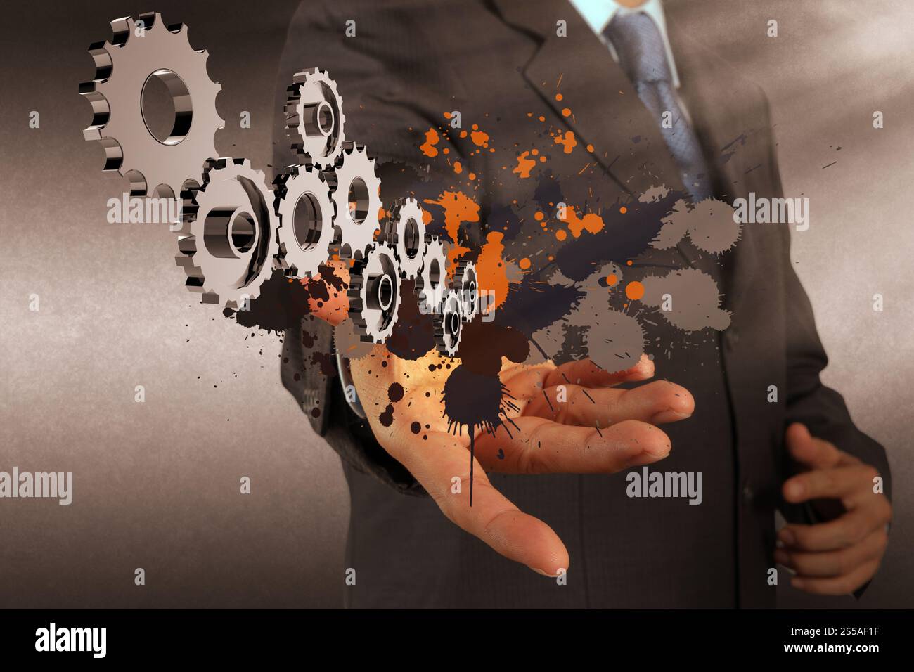 Businessman working avec pignon et splash couleurs en tant que concept Banque D'Images