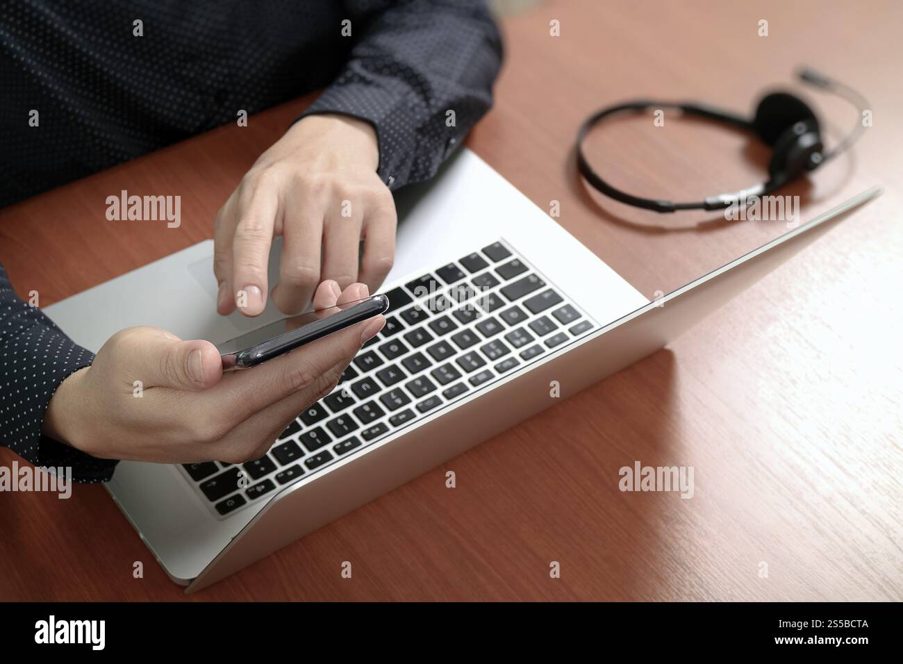 Main d'homme utilisant un casque VoIP avec clavier intelligent d'accueil pour tablette numérique, communication conceptuelle, support informatique, centre d'appels Banque D'Images