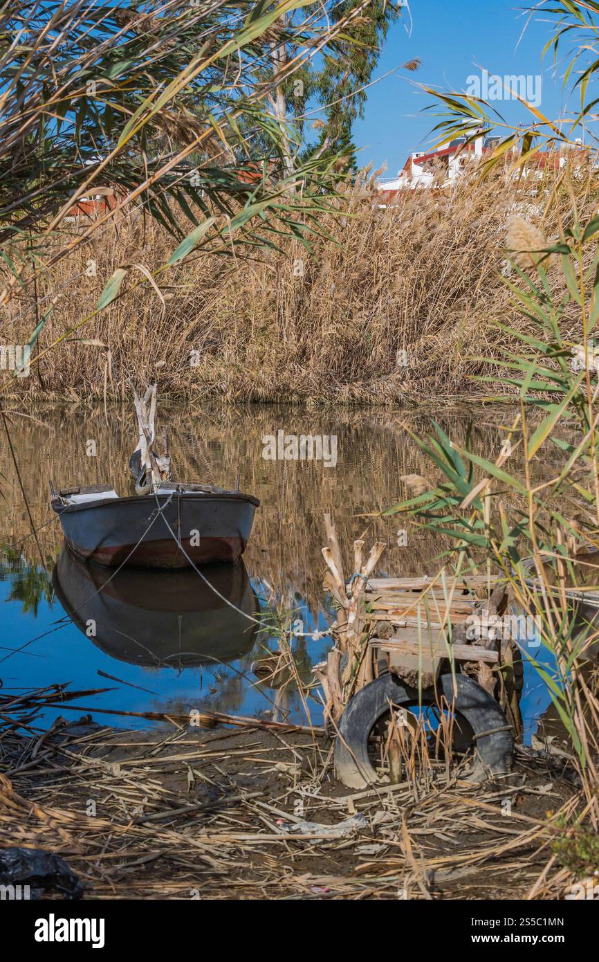 bateau à rames accosté parmi les roseaux dans la rivière Banque D'Images