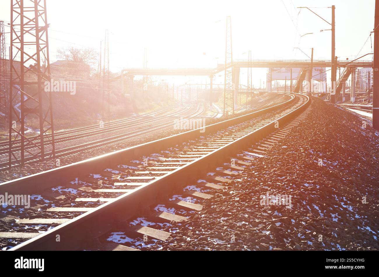 Paysage d'un chemin de fer d'hiver russe enneigé sous la lumière du soleil les rails et les traverses sous la neige de décembre. Chemins de fer russes en détail. Hiver Banque D'Images