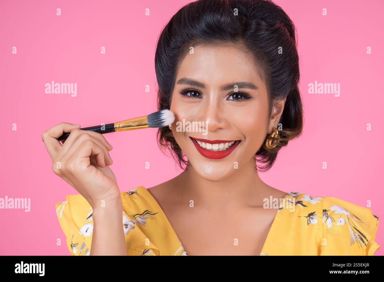 Portrait d'une femme avec un spectacle professionnel de pinceau à maquillage Banque D'Images