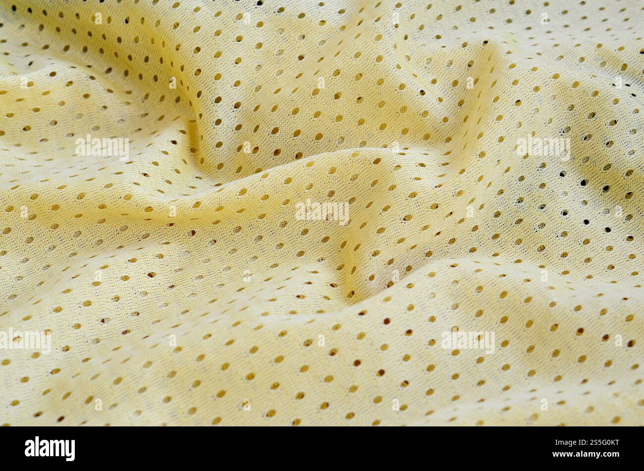 Fond de modèle textile de tissu de tissu de sport de maille jaune. Couleur jaune maillot de football vêtements tissu texture vêtements de sport. Poreux respirant Banque D'Images