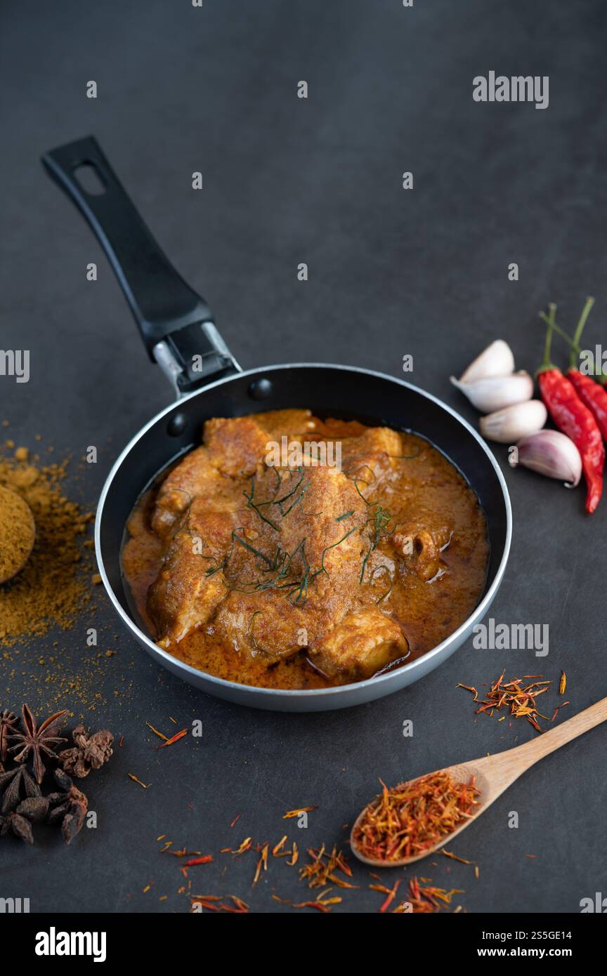 Curry Massaman dans une poêle avec des épices sur le sol en ciment. Mise au point sélective Banque D'Images