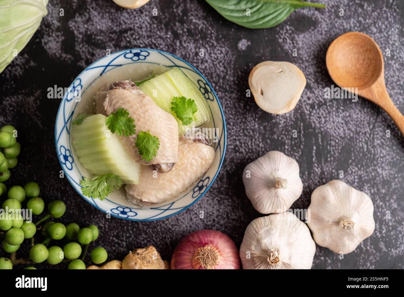 Soupe claire au poulet à éclosion verte avec ail, citron, oignon, oignon rouge, champignon et basilic. Banque D'Images