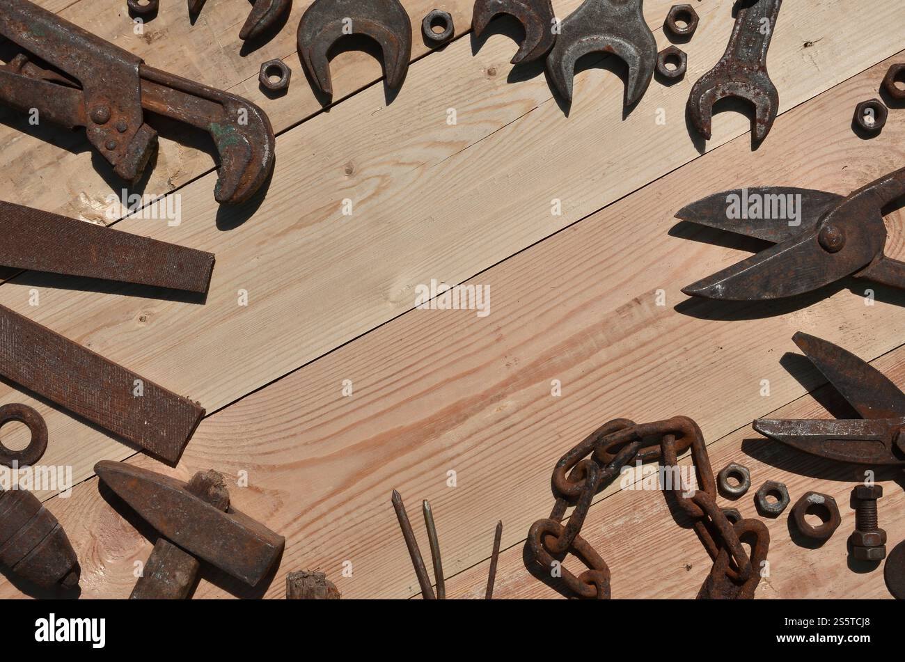 Un ensemble d'outils vieux et rouillés pour bricoleur. Beaucoup d'outils ménagers obsolètes en métal rouillé reposent sur une table en bois dans l'atelier. Le concept de Banque D'Images