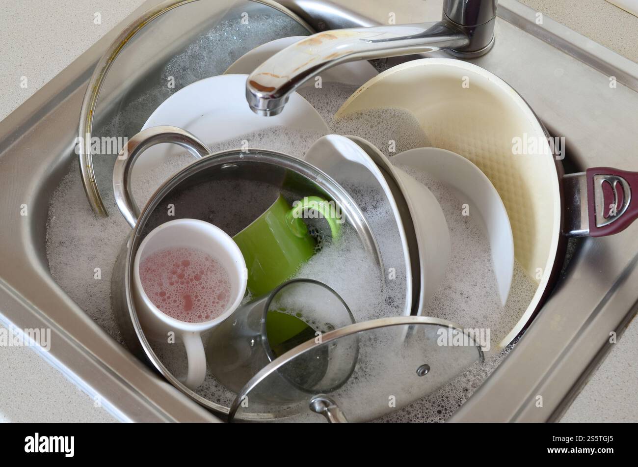 Des plats sales et des appareils de cuisine non lavés ont rempli l'évier de cuisine Banque D'Images