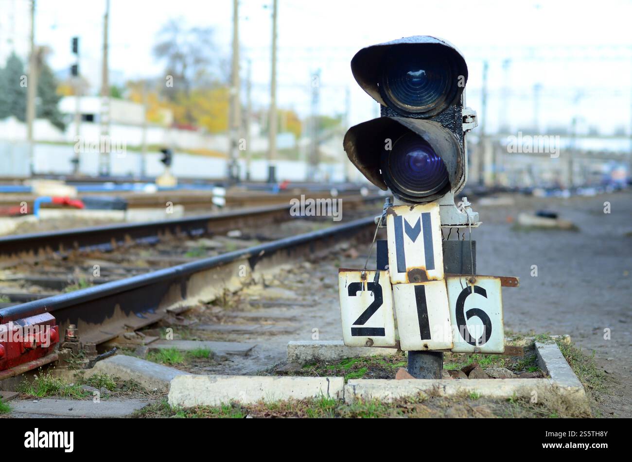 Feu de circulation sémaphore ferroviaire sur fond d'un paysage ferroviaire de jour. Dispositif de signalisation sur la voie ferrée. Sémaphore avec bleu brûlant Banque D'Images