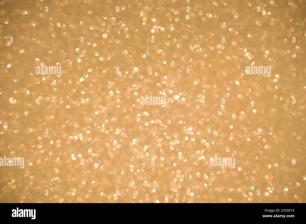 Fond doré scintillant. Spots à effet flou chatoyant bokeh texture de fond clair or brillant Banque D'Images