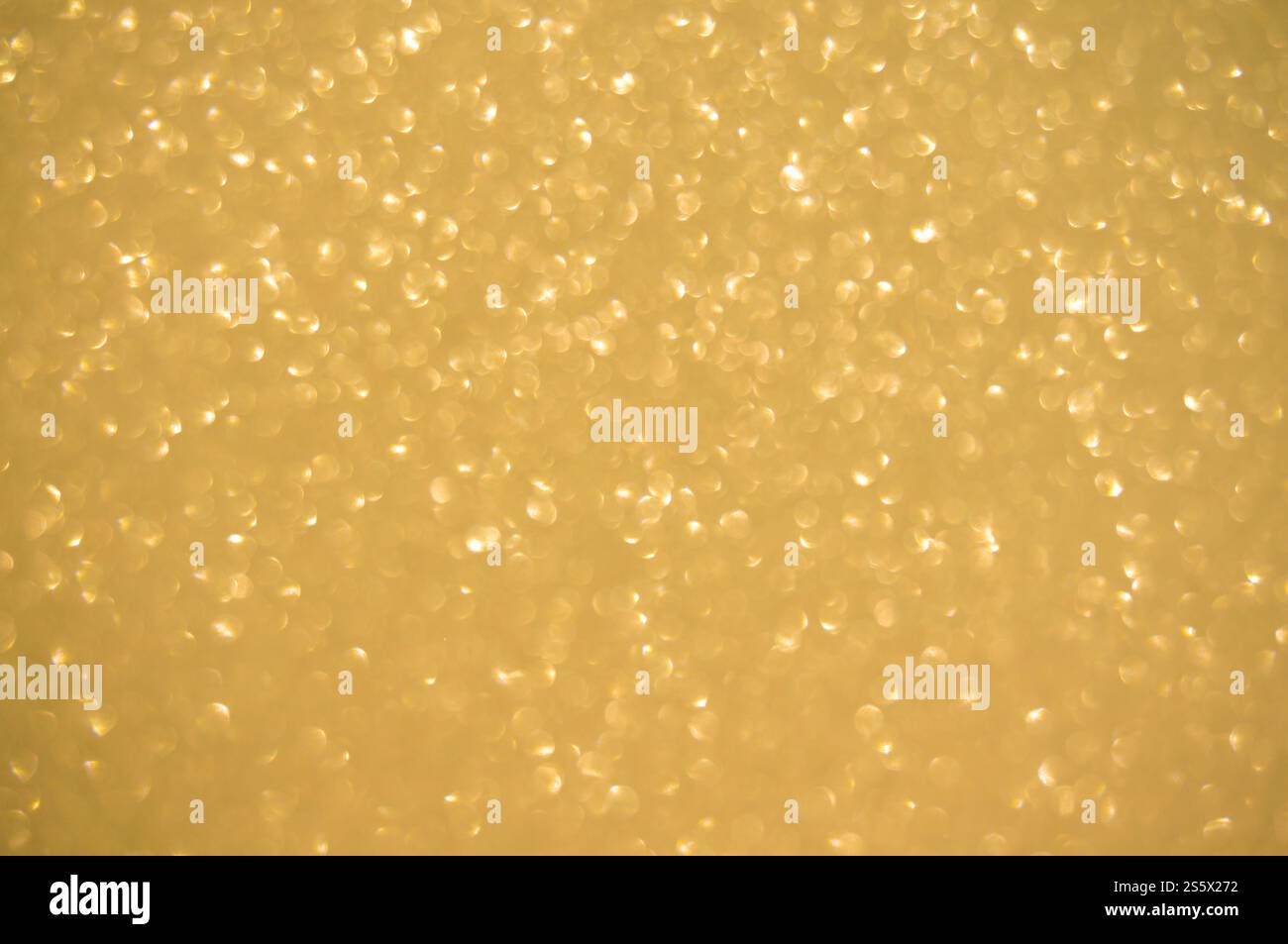 Fond doré scintillant. Spots à effet flou chatoyant bokeh texture de fond clair or brillant Banque D'Images