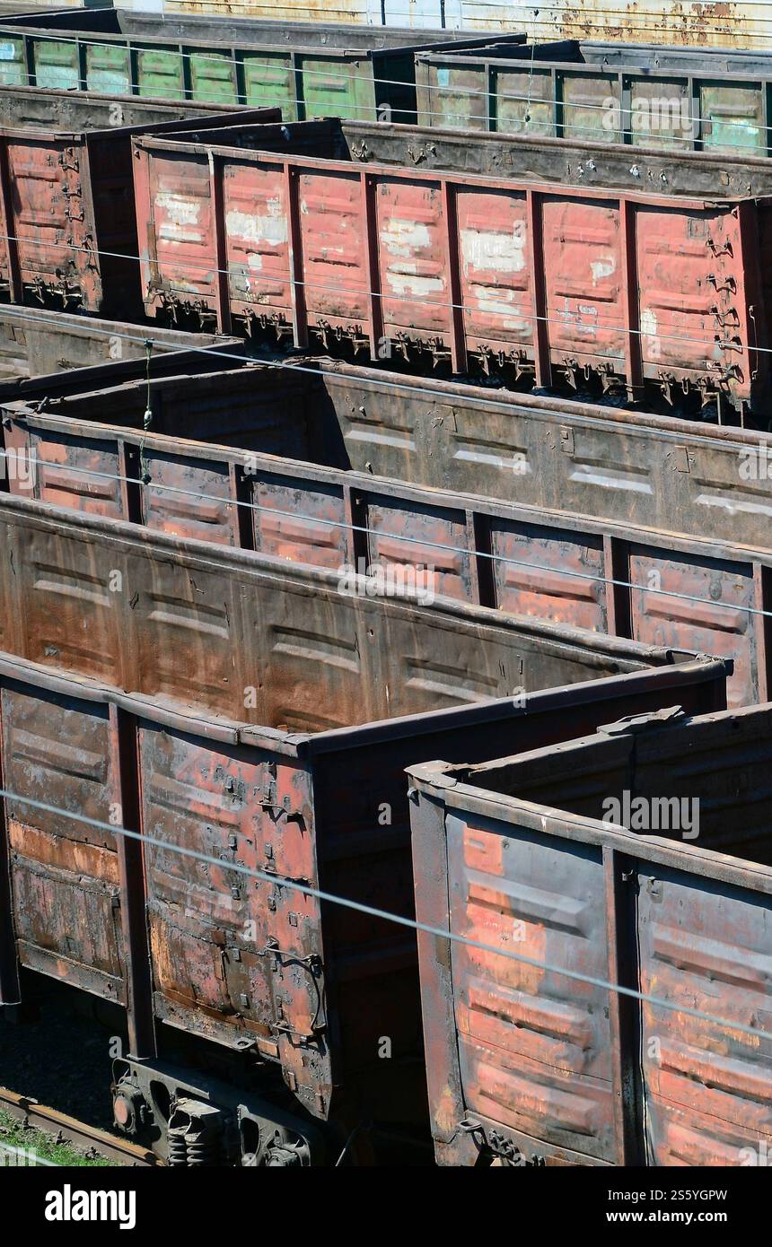 Vieux wagons de train rouillés vides sur les rails le jour d'été. Wagons sales à la lumière du soleil sous l'air libre. Vieux wagons de train rouillés vides sur les rails le jour d'été Banque D'Images