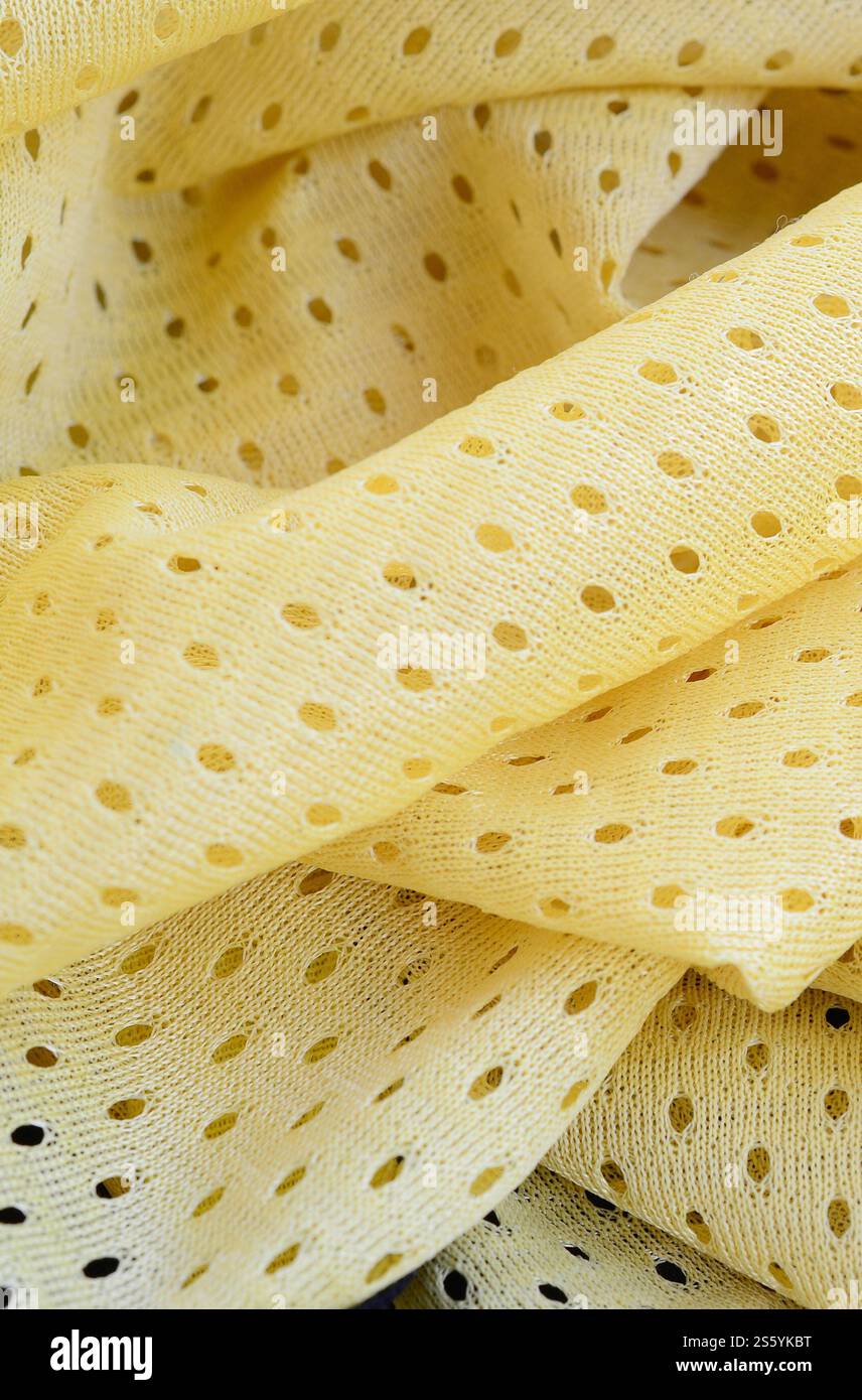 Fond de modèle textile de tissu de tissu de sport de maille jaune. Couleur jaune maillot de football vêtements tissu texture vêtements de sport. Poreux respirant Banque D'Images