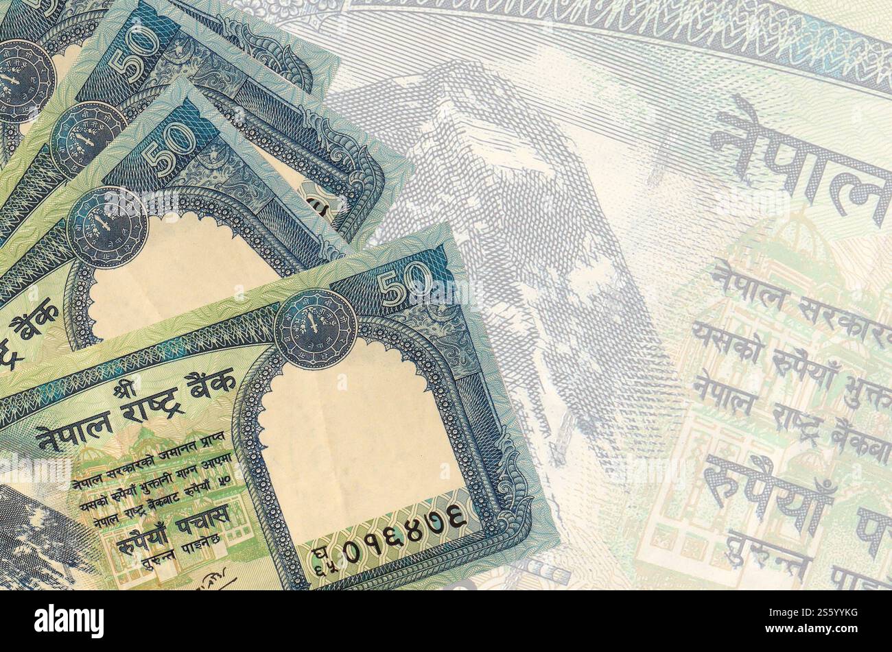 50 billets de roupies népalaises se trouve dans la pile sur fond de gros billet de banque semi-transparent. Fond d'entreprise abstrait avec espace de copie. 50 Népalais Banque D'Images