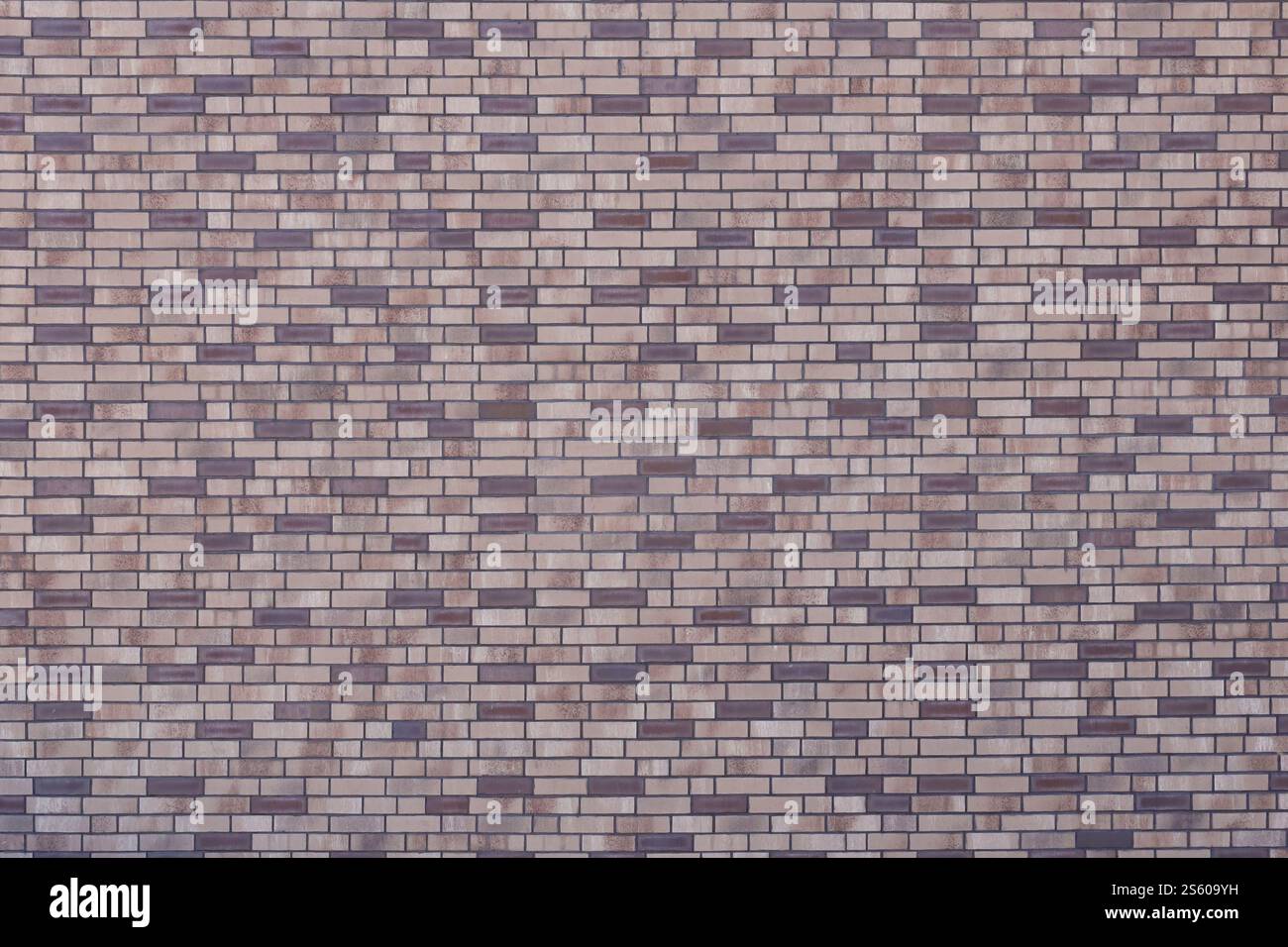 Motif de mur de briques foncées avec ordre de maçonnerie chaotique. Texture d'arrière-plan ou ressource pour texturation 3D. Beaucoup de briques dans le grand mur de pierre moderne en plein Banque D'Images