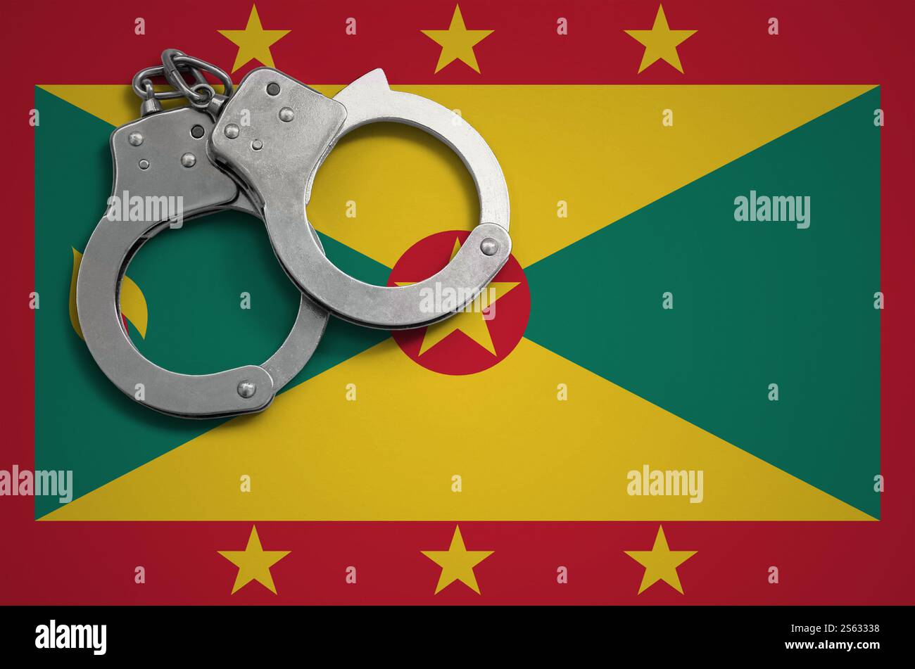 Drapeau de la Grenade et menottes de police. La notion de crime et de délits dans le pays. Drapeau de la Grenade et menottes de police. Le concept de crime et Banque D'Images