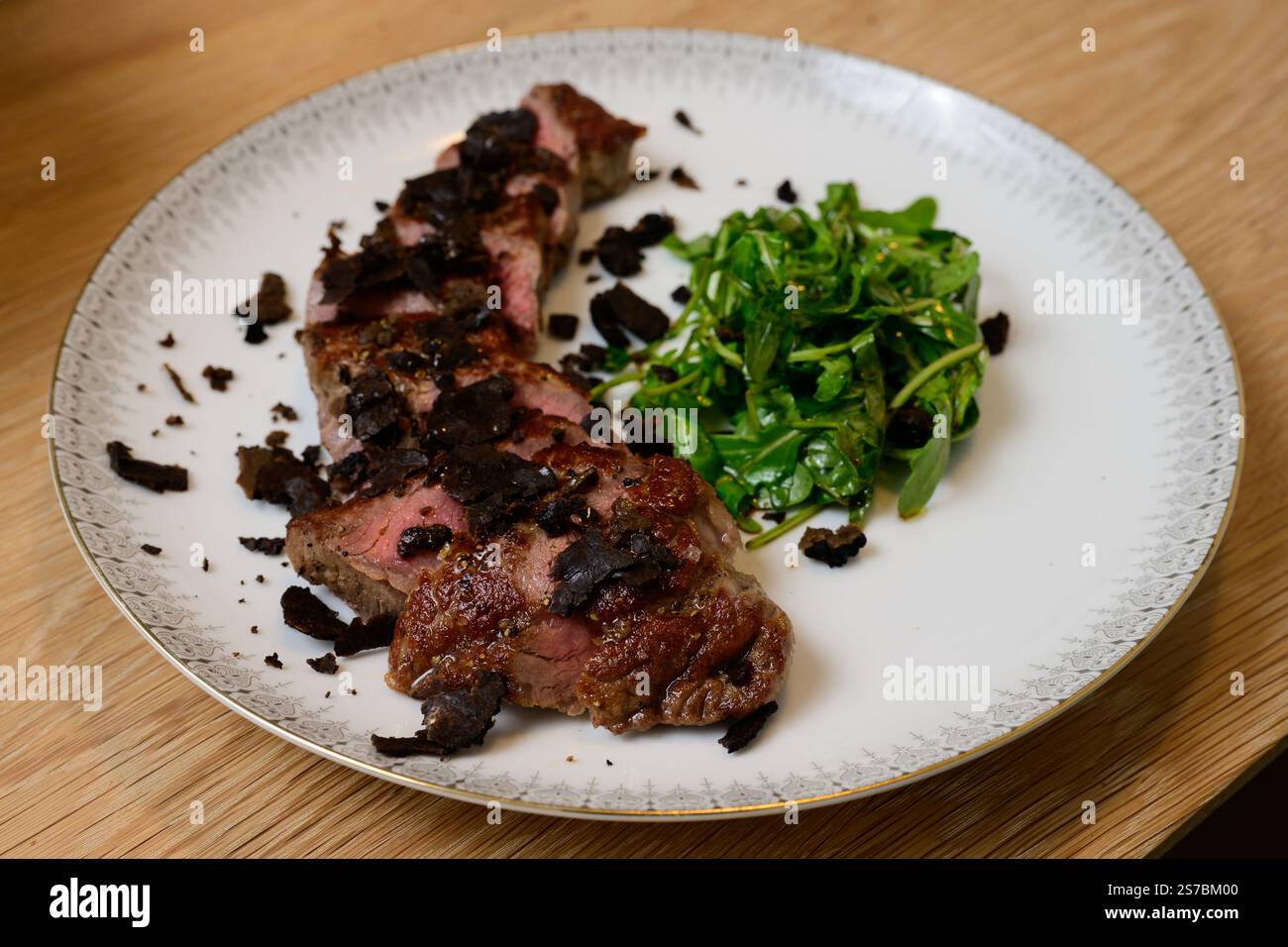 Tagliata di Manzo al Tartufo bœuf tranché avec truffes servi avec une salade de roquette verte ou d'Arugula Banque D'Images