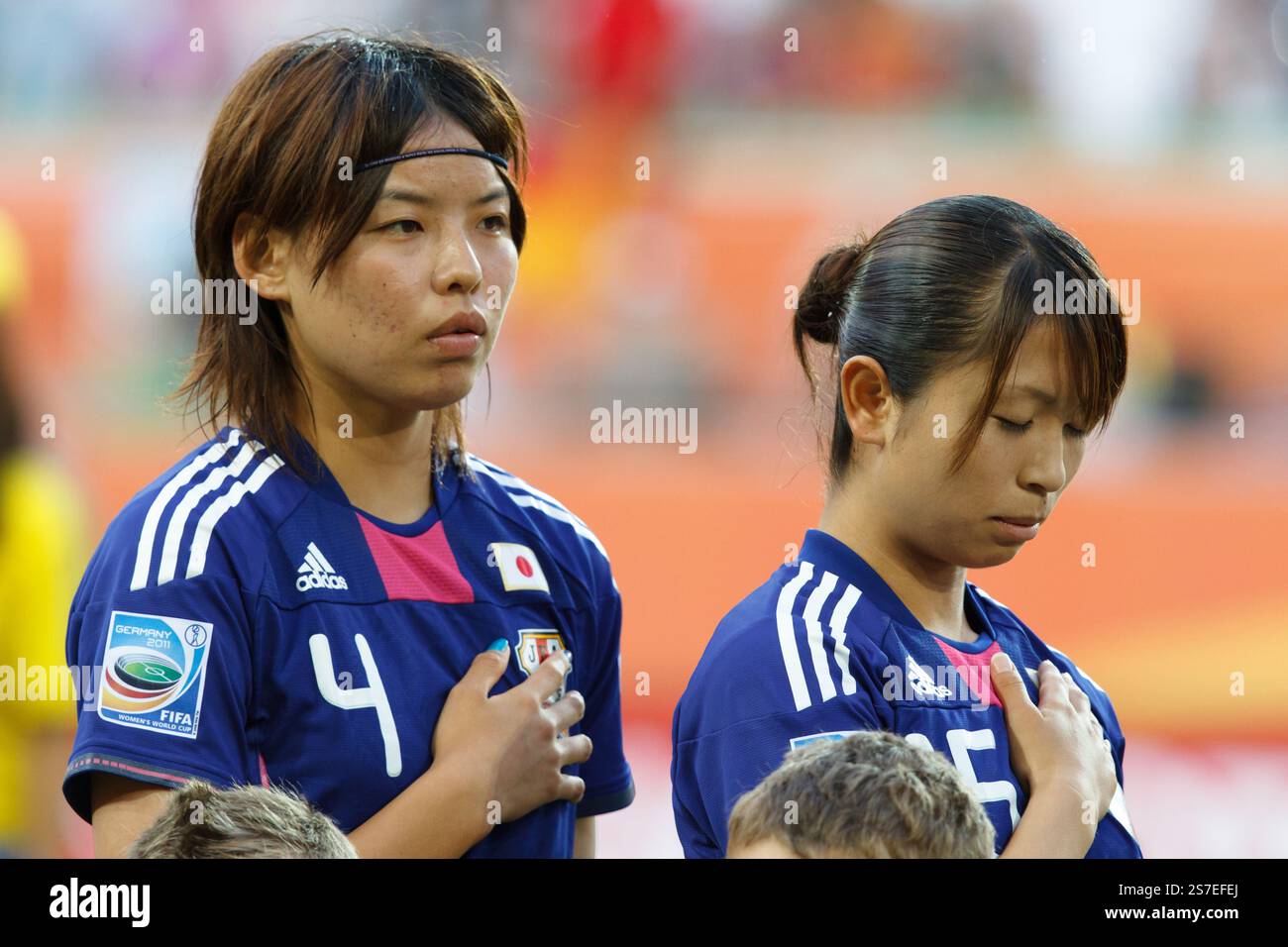 Les joueuses japonaises Saki Kumagai (G) et Aya Sameshima (d) représentent l'hymne national avant un match de quart de finale de la Coupe du monde féminine de la FIFA contre l'Allemagne le 9 juillet 2011 à l'Arena Im Allerpark de Wolfsburg, en Allemagne. Usage éditorial exclusif. Utilisation commerciale interdite. Banque D'Images