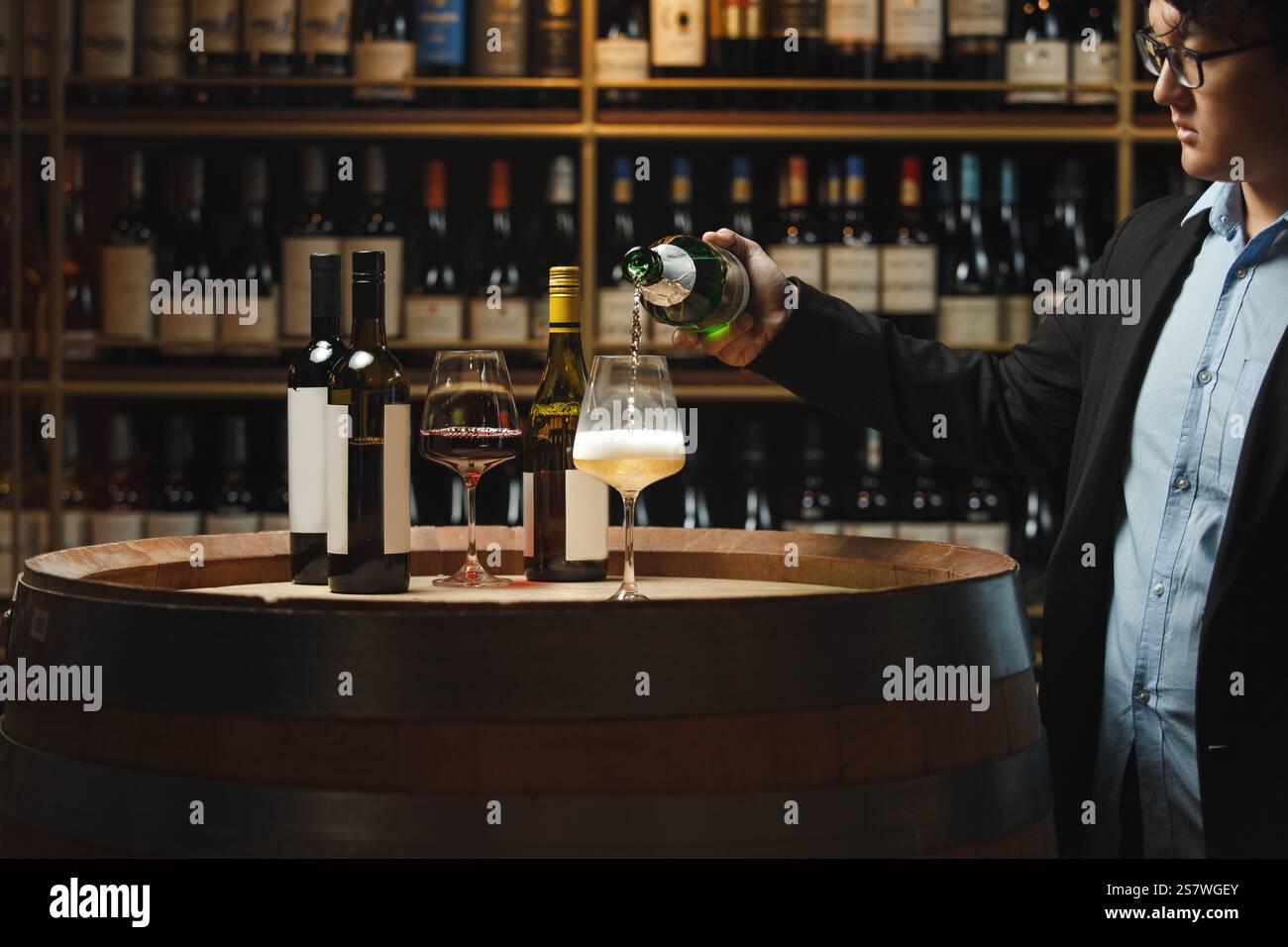 Sommelier versant du vin mousseux dans la cave Banque D'Images