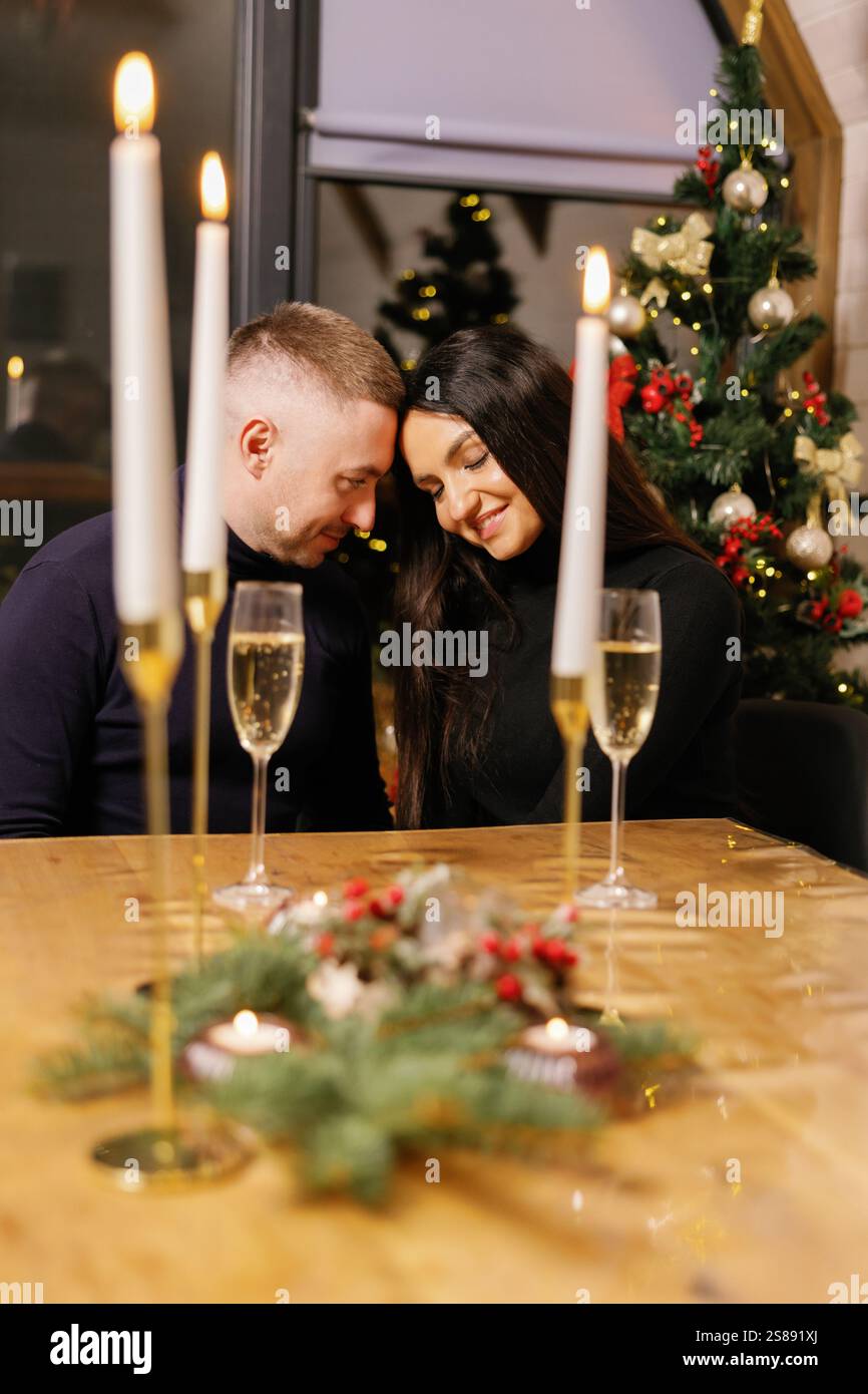 Couple profitant d'un dîner romantique avec des bougies et du champagne, créant une atmosphère chaleureuse et festive Banque D'Images Couple profitant d'un dîner romantique avec des bougies et du champagne, créant une atmosphère chaleureuse et festive Banque D'Images