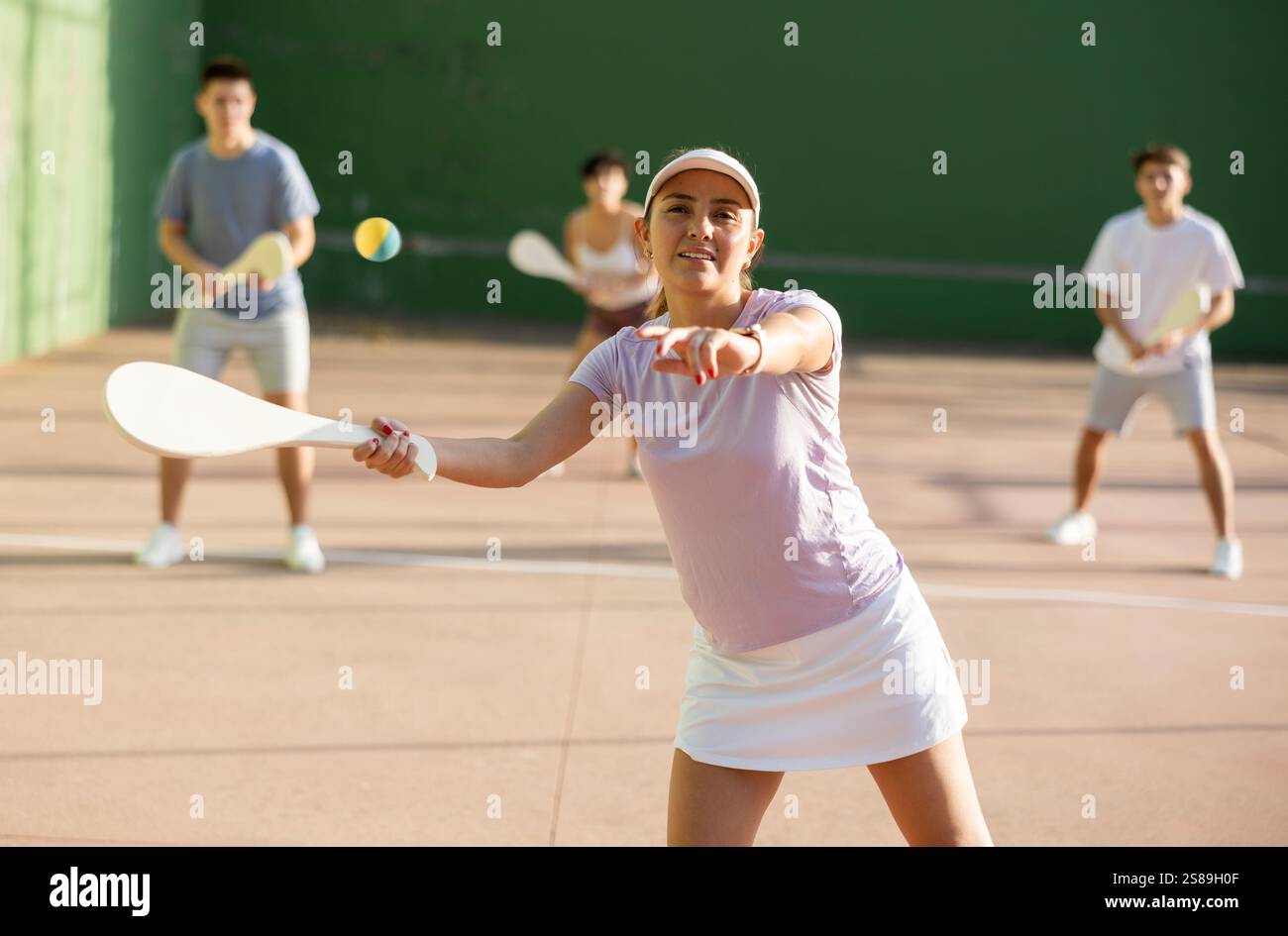 Femme basque pelote joueur frapper balle avec raquette en bois Banque D'Images