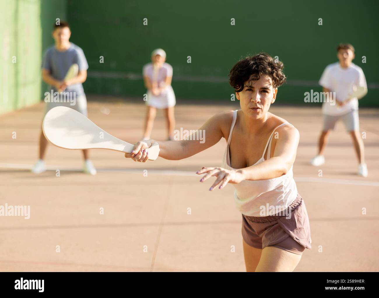 Femme jouant la pelote basque sur le terrain extérieur de pelote Banque D'Images