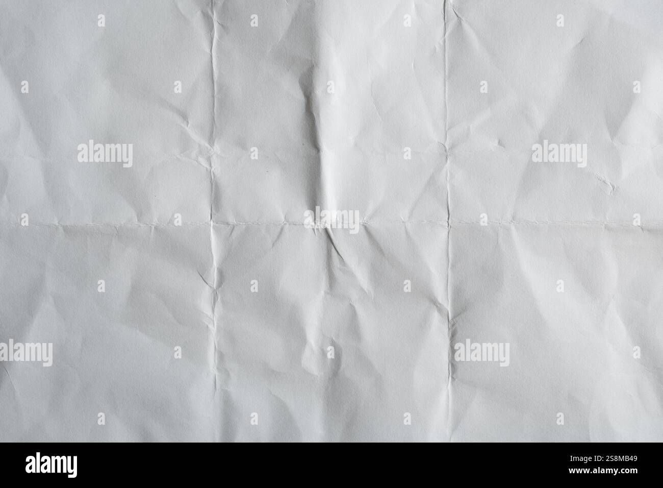 Texture du papier froissé plié avec des zones claires et sombres Banque D'Images
