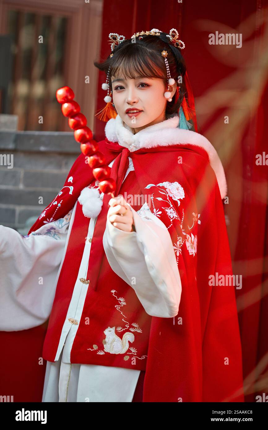 Fille asiatique portant Hanfu rouge chinois à l'extérieur un jour neigeux Banque D'Images