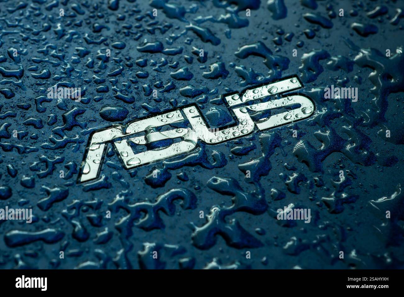 UKRAINE, DNEPR - OCT 02, 2023 : logo de la société ASUS sur ordinateur portable avec des gouttes d'eau. Banque D'Images