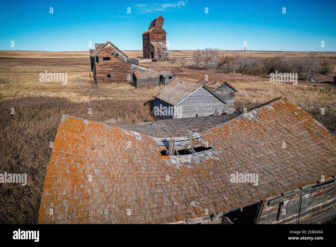 Une maison avec un toit qui est brun et a de la mousse dessus. La maison est vieille et a beaucoup de rouille Banque D'Images