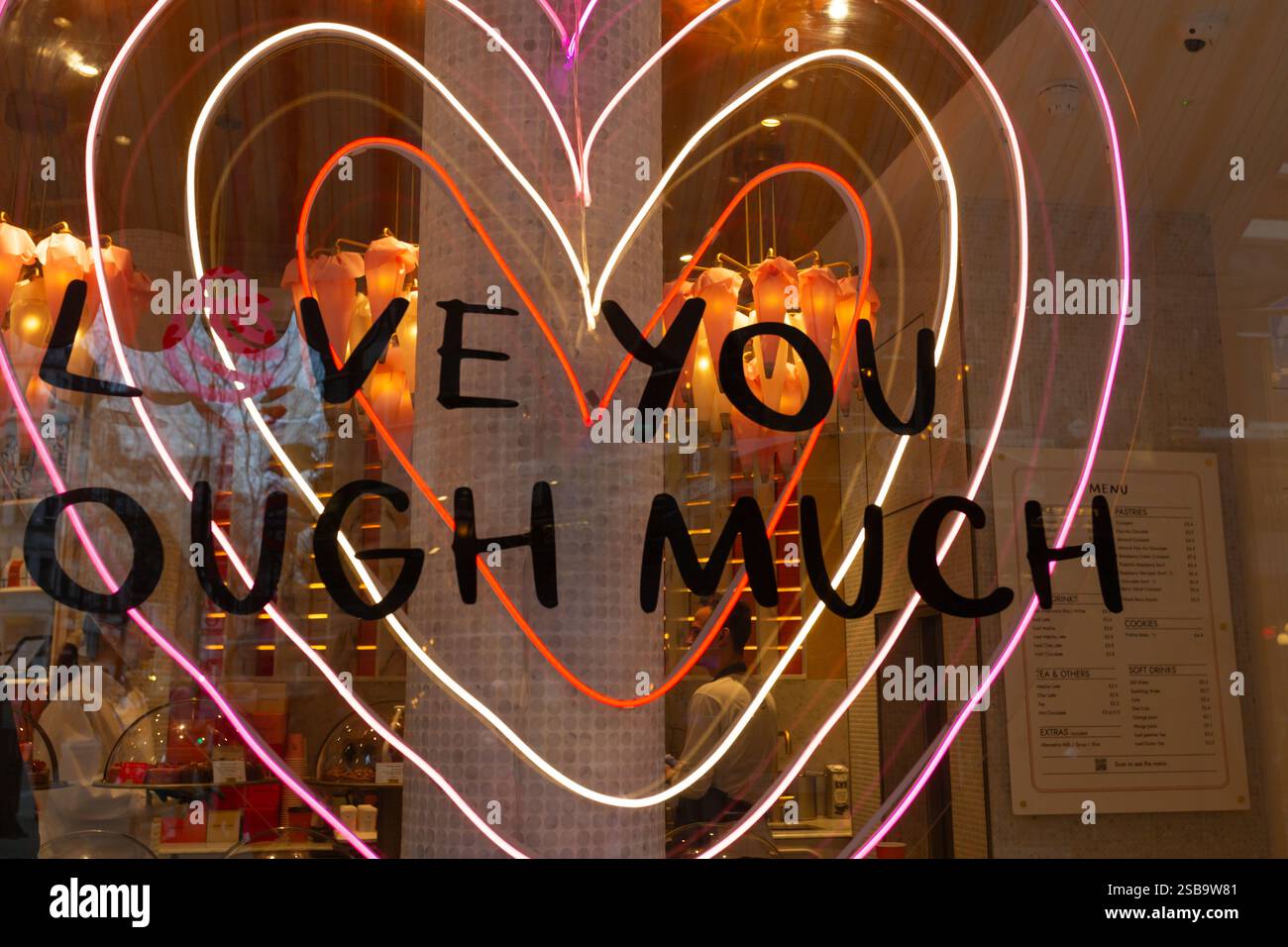 Vue rapprochée sur la vitrine du magasin Donutelier avec le panneau LED en forme de cœur « Love You Dough Much » illuminé Londres, Grande-Bretagne. Banque D'Images