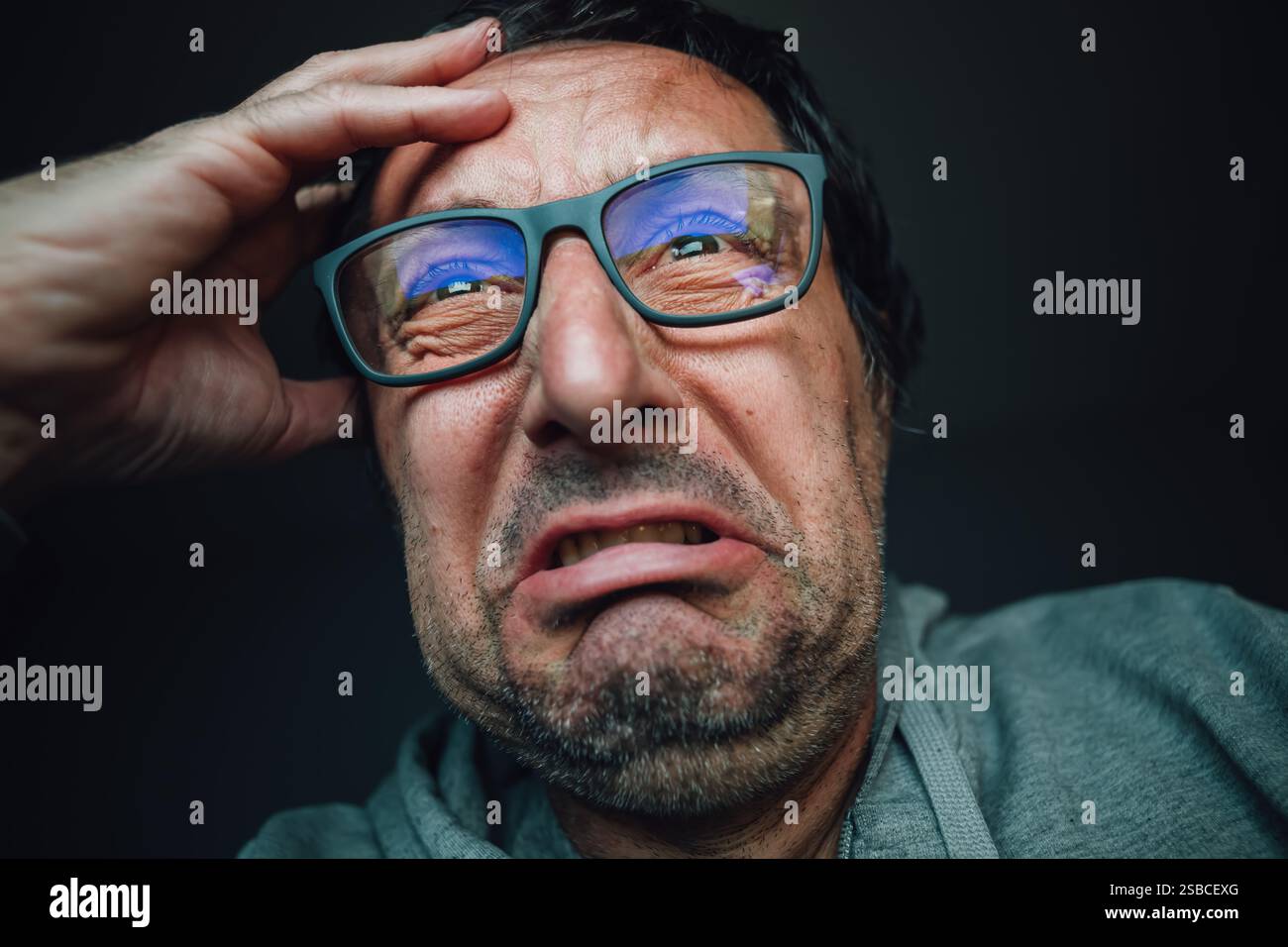 Dépression nerveuse et fusion mentale, détresse mentale intense ou maladie, portrait d'homme en détresse avec des lunettes pleurant de désespoir, foc sélectif Banque D'Images