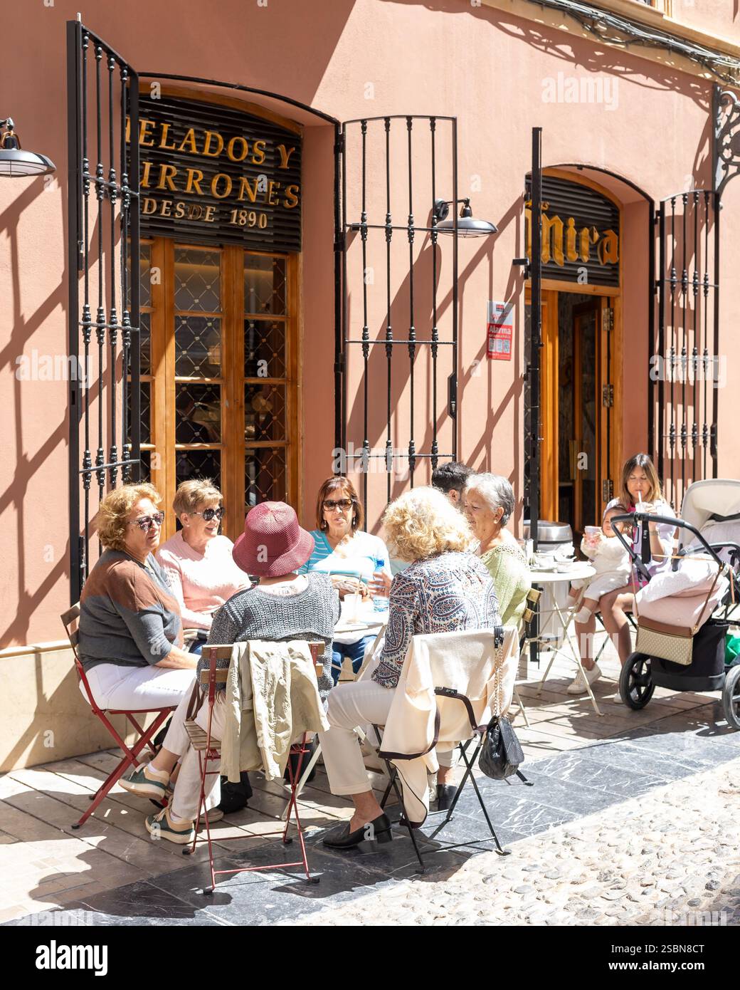 Amis prenant un verre sur une terrasse dans le centre historique de Malaga Banque D'Images
