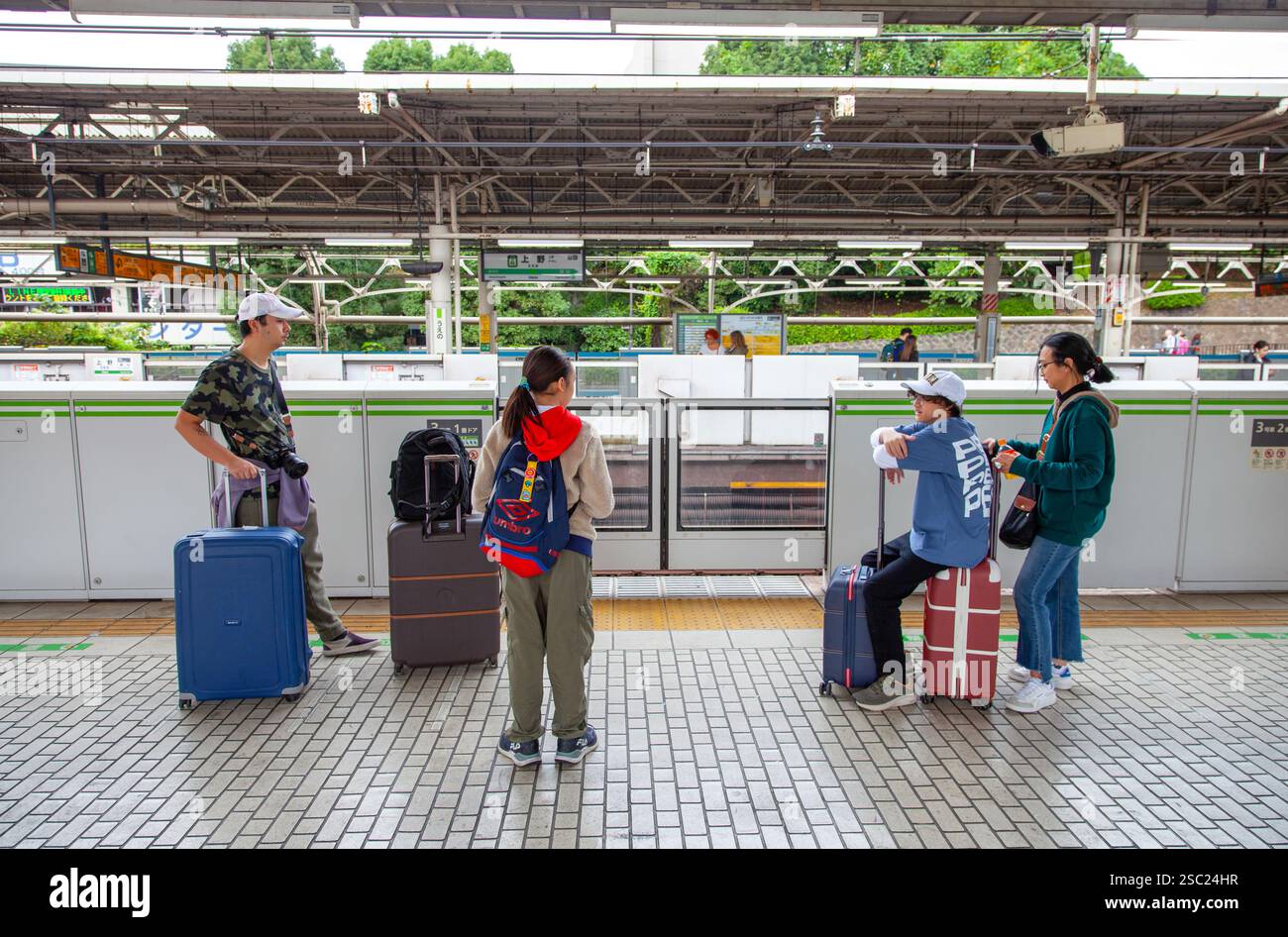 Une famille attend un train à la gare Ueno de Tokyo au Japon. Banque D'Images