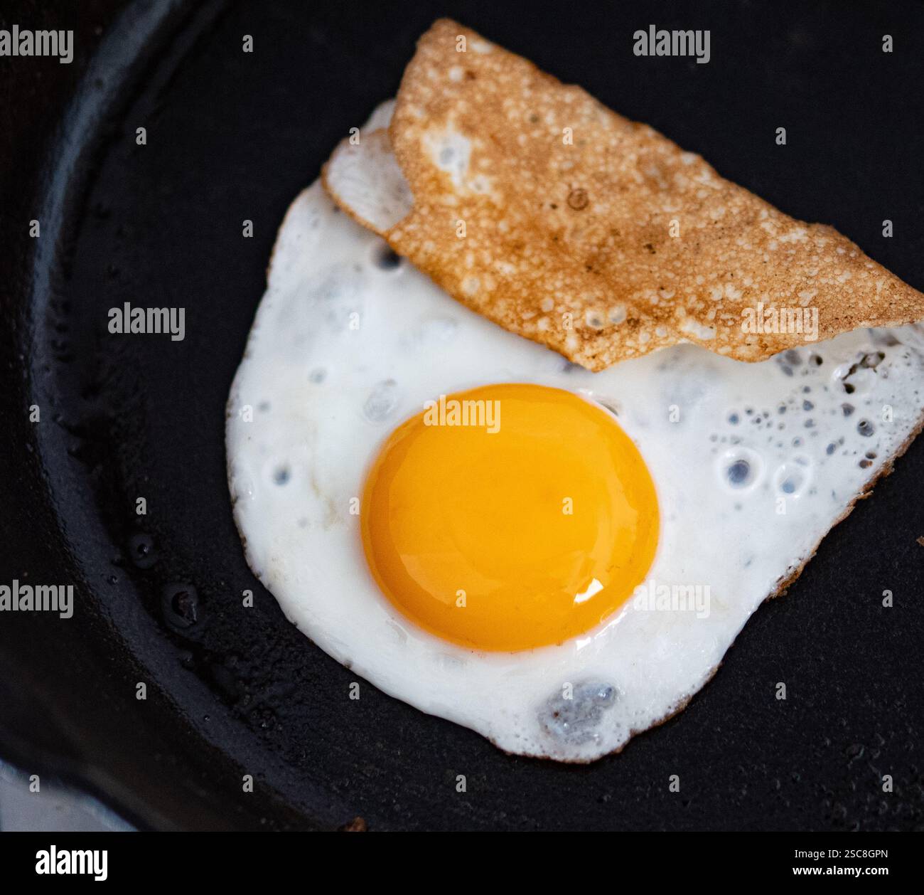 Oeuf frit dans une poêle en fonte Banque D'Images