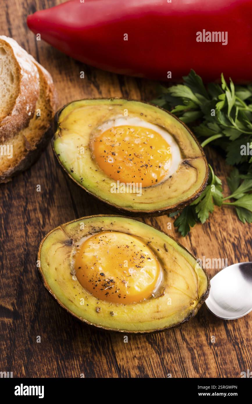 Oeufs bio faits maison cuit dans avocat avec sel et poivre Banque D'Images